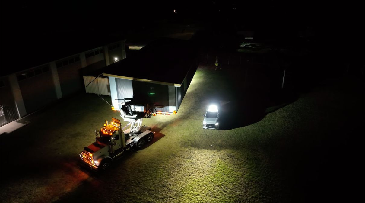 Our transport team rolling a double classroom onto site.
