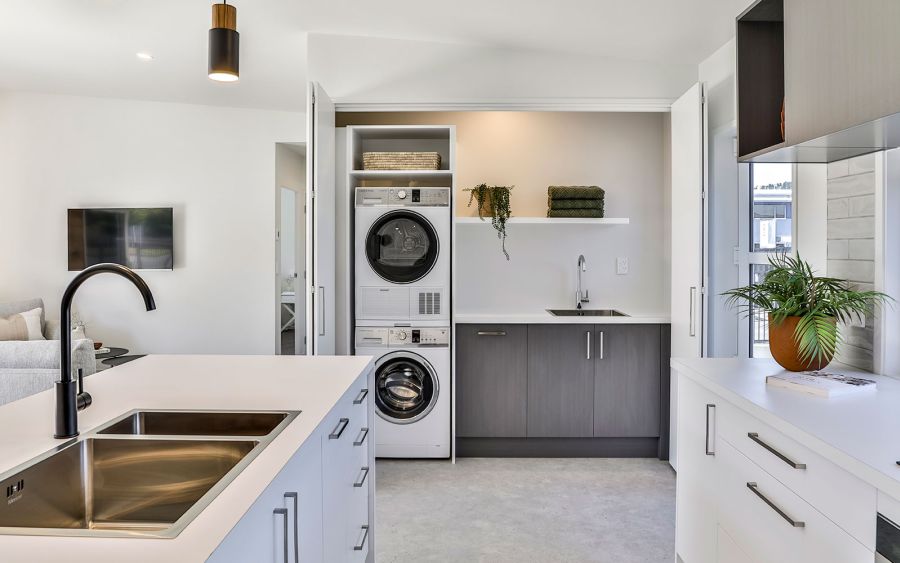 Kitchen with island bench and built-in laundry cupboard
